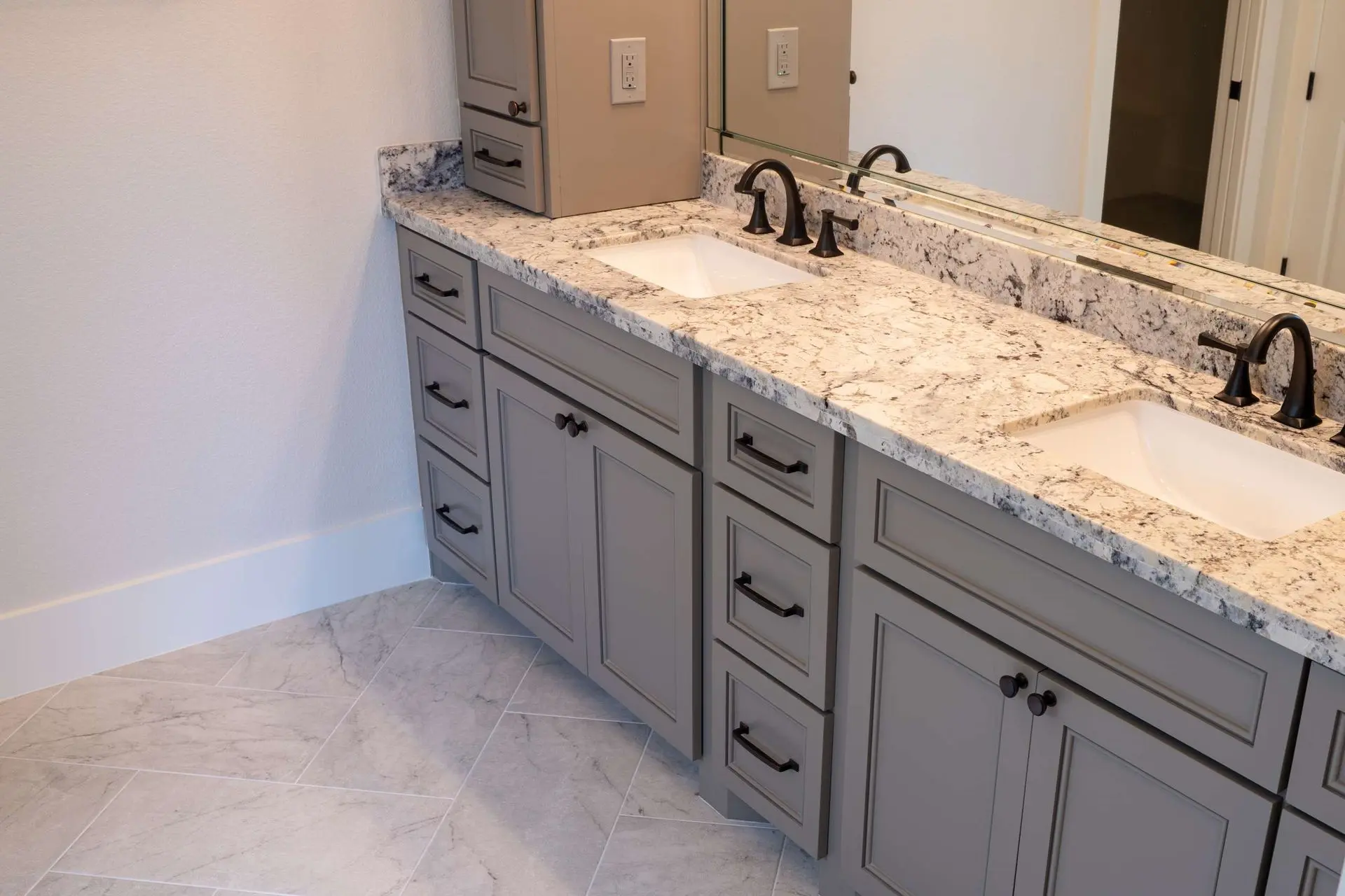 Double vanity with granite countertop gray shaker cabinets and oil rubbed bronze fixtures in Pearland TX