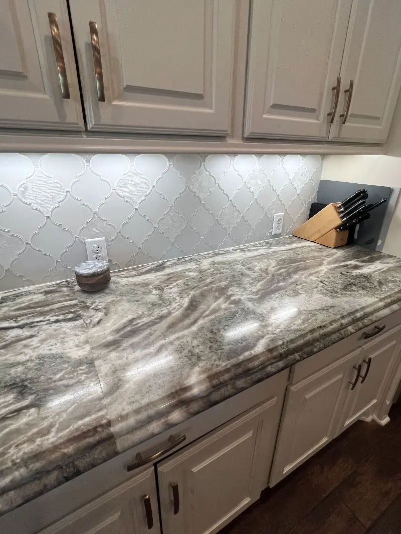 Fantasy Brown granite countertops with cream cabinets and arabesque backsplash in Texas City