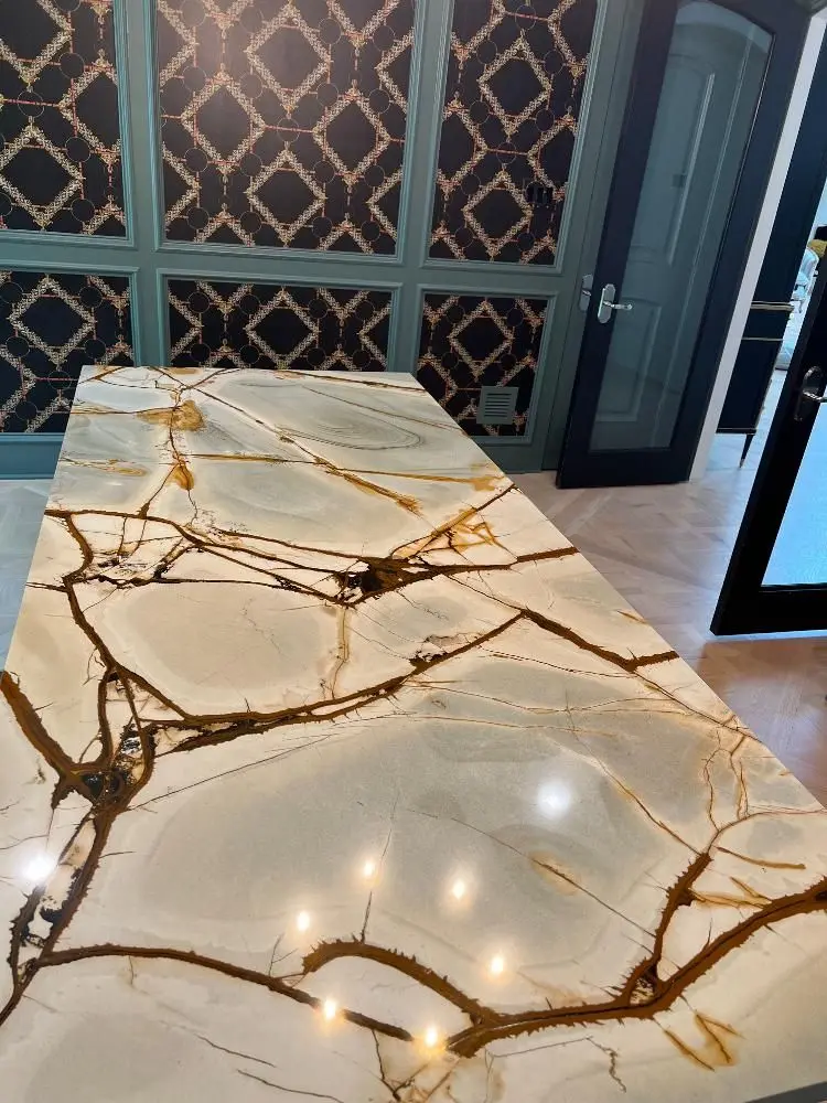 Exotic Patagonia quartzite island with dramatic gold veining and designer wallpaper in Alvin TX
